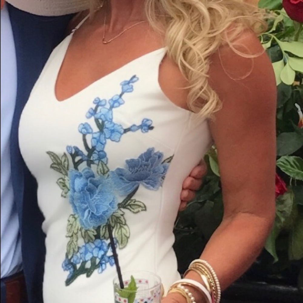 White dress with blue embroidered flowers.
